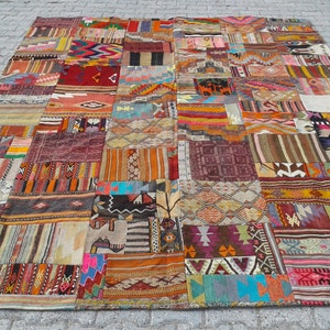 May include: A large, colourful patchwork rug made from various pieces of fabric. The rug features a variety of geometric patterns and colours, including red, blue, green, yellow, and orange.