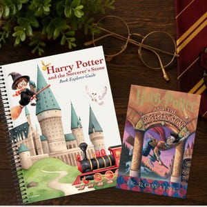 May include: A spiral-bound book titled Harry Potter and the Sorcerer's Stone Book Explorer Guide featuring a cartoon illustration of a castle, a train, and a character on a broomstick, alongside a paperback copy of the book with a colorful cover.