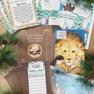 May include: A collection of educational activity sheets and a book titled The Lion, the Witch and the Wardrobe. The materials include an Explorer Challenge card, a discovery folder, and a chapter chart featuring illustrations of a lion.