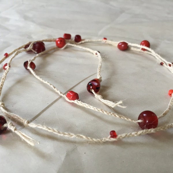 All purpose braided and looped cream colored hemp cord adorned with ruby red glass cabochons