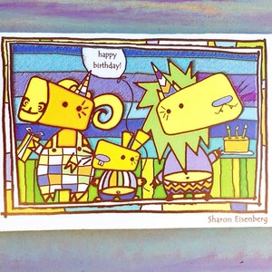 May include: A colorful birthday card featuring three cartoon characters with yellow bodies and geometric patterns. One character holds a gift, another has a speech bubble that says "happy birthday!" A cake with candles is also visible.