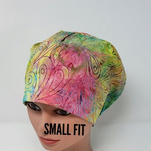 May include: A colorful surgical scrub hat with a paisley pattern in shades of pink, green, and yellow. The hat is labeled "SMALL FIT".