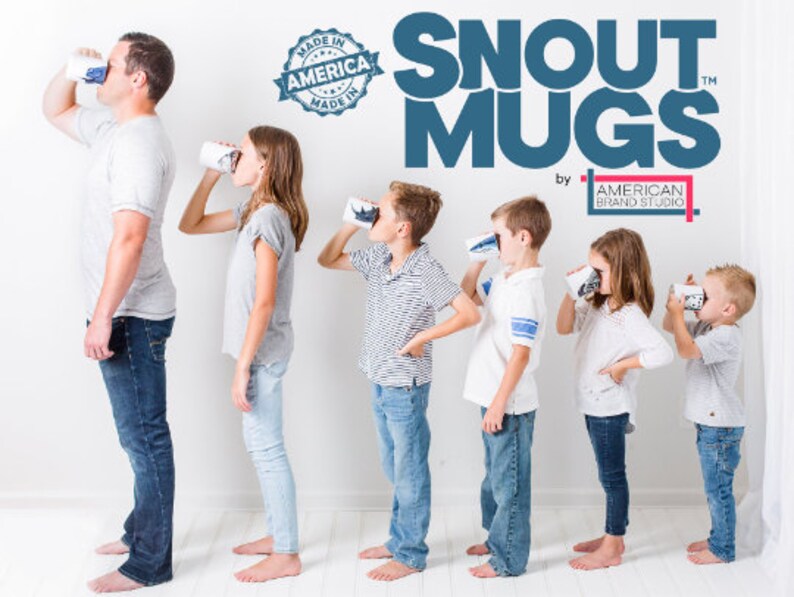 May include: A group of people of different ages are drinking from blue and white ceramic mugs with a dog snout design. The mugs are labeled 'Snout Mugs' with the text 'by American Brand Studio' below. The text 'Made in America' is in a blue circle with a white star in the center. The mugs are part of a product line for dog lovers.