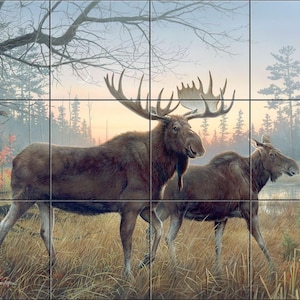 May include: A painting of two moose in a natural setting. The larger moose has large antlers and stands in tall grass. The background features a forest, a lake, and a cabin under a dusky sky.