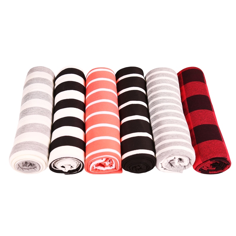 May include: Six rolled fabric items in various patterns and colors. The patterns include stripes in black and white, gray and white, and coral and white. One item features a red and black buffalo plaid pattern.