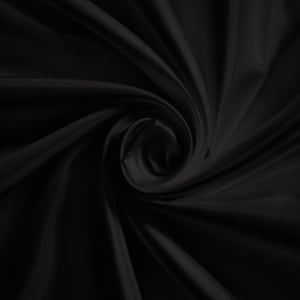 May include: Black fabric with a smooth, silky texture. The fabric is draped and folded to create a swirling pattern.