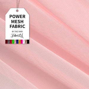 May include: A close-up of pink power mesh fabric. A white tag with the words "POWER MESH FABRIC" and "BY THE YARD" is attached to the fabric. The brand name "FabricLA" is also visible on the tag. A color palette is at the bottom of the tag.