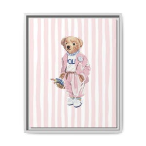 May include: A framed print showing a teddy bear in a pink suit, white shirt, and white shoes, holding a basket of flowers. The background is striped in pink and white. The bear has a blue scarf.