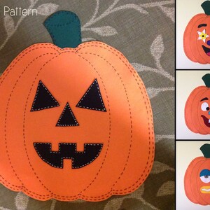 May include: Three orange felt pumpkins with different facial expressions. The first pumpkin has a happy face with white flowers for eyes. The second pumpkin has a surprised expression with a blue tongue sticking out. The third pumpkin has a sad expression with blue eyes and a frown.