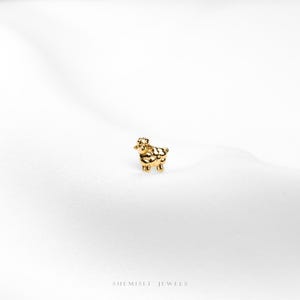a close up of a gold ring on a white surface