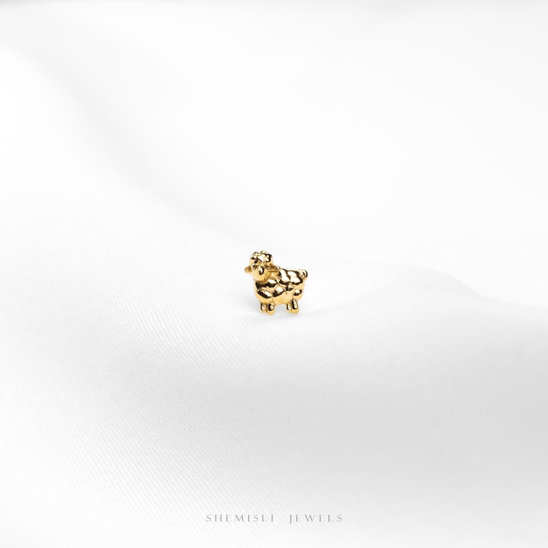 a close up of a gold ring on a white surface