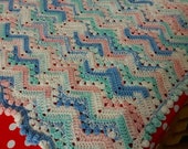 Handmade crochet ripple baby blanket with pom pom trim