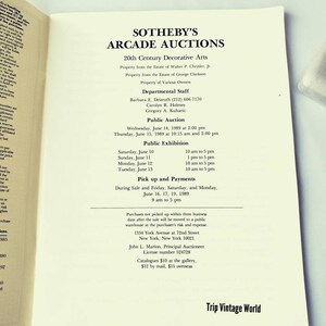 May include: A black and white printed page with the text "Sotheby's Arcade Auctions" and information about a public auction of 20th century decorative arts. The auction will take place on June 14 and 15, 1989, at 1334 York Avenue in New York City.