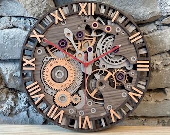 May include: A circular wall clock with a layered wooden design featuring exposed mechanical gears in shades of brown, gray, and copper. It has copper Roman numerals, red clock hands, and text that reads "Vyva Studio New Zealand Time Is Priceless."