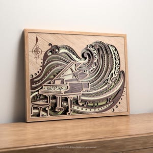 May include: A framed, multi-layered wooden art piece featuring a grand piano. The artwork uses shades of brown, green, and cream to depict a piano with a wave-like design. A musical note and compass rose are in the upper left corner.