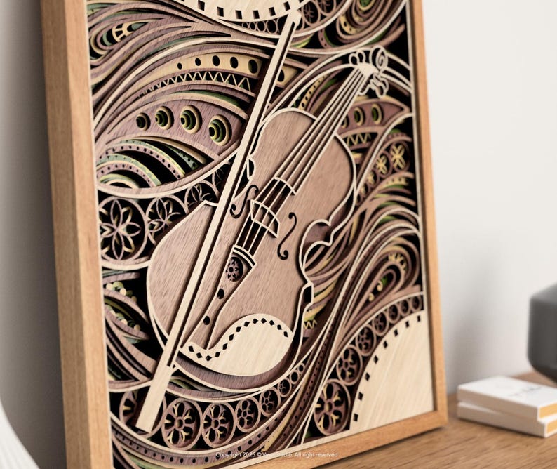 May include: A wooden layered art piece featuring a violin and bow. The artwork is framed in a light brown wooden frame. The violin and bow are light brown, with a detailed design. The background has a layered, wave-like pattern in shades of brown and green.