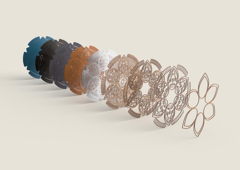 May include: A series of laser-cut mandala designs in shades of blue, black, orange, white, and gold. The detailed patterns are arranged in a row, demonstrating the intricate craftsmanship and artistic style. Measurements are in centimetres.