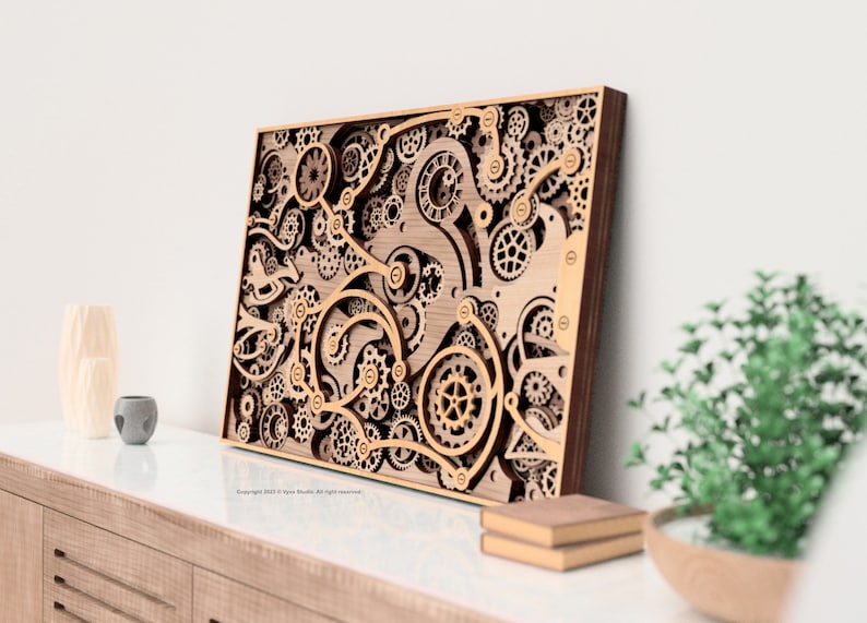 May include: Wooden wall art featuring a layered design of gears and mechanical components. The artwork has a natural wood finish with a dark brown frame. The intricate design creates a three-dimensional effect, perfect for home decor.