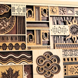 May include: Wooden wall art with a layered design. The artwork features various geometric and natural elements, including a clock, sun, trees, and abstract shapes, all in shades of brown and tan. The piece is framed in light wood.