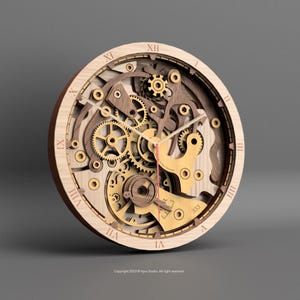 May include: A wooden wall clock with exposed gears and a layered design. The clock features Roman numerals in a light brown color, with gold and brown gears visible through the face. The clock hands are red. The clock is approximately 12 inches in diameter.