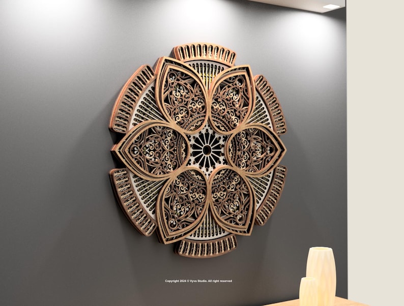 May include: A decorative wooden wall art piece with a floral design. The artwork has intricate cut-out patterns and a multi-layered construction. The colour palette includes shades of brown, beige, and black, creating a dimensional effect. It is mounted on a grey wall.