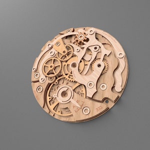 May include: A wooden wall art piece depicting the intricate inner workings of a watch. The artwork features a layered design with various gears, springs, and other mechanical components. The natural wood color contrasts against the gray background.