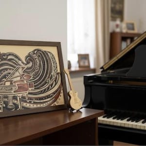 May include: A framed wooden art piece depicts a grand piano with musical notes and wave-like patterns in shades of brown and beige. A small wooden guitar sits beside it. A black grand piano is in the background.