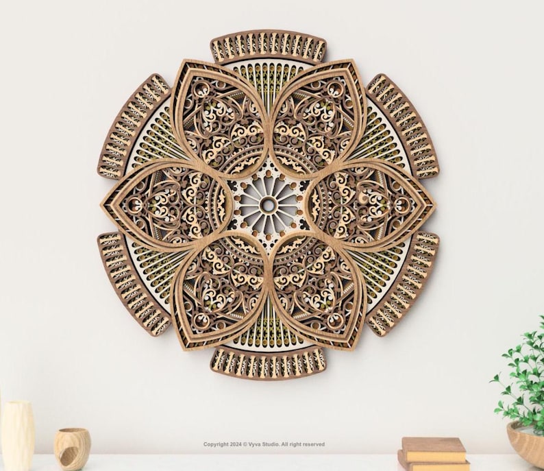 May include: A layered wooden wall art piece in a floral design. The artwork features intricate cut-out patterns and a multi-layered construction. The colour palette includes shades of brown, beige, and white. The piece is mounted on a white wall.