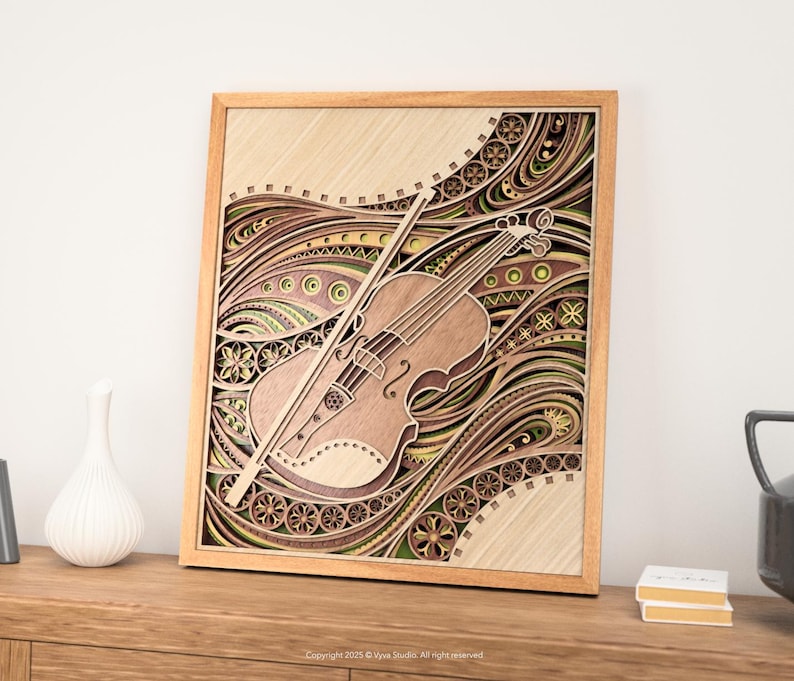 May include: A wooden layered art piece featuring a violin and bow. The artwork is framed in a light wood and showcases intricate patterns in shades of brown, green, and beige. The violin is positioned diagonally, with the bow resting across it.
