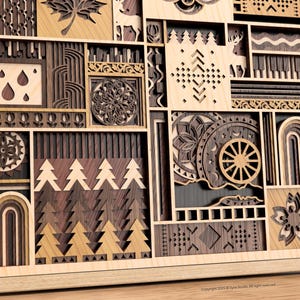 May include: Wooden wall art with a layered design. The artwork features various geometric and nature-inspired shapes, including trees, leaves, and deer, in shades of brown and tan. The piece is framed in light wood.