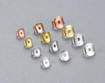 May include: Assortment of earring backs in silver, gold, and rose gold. Each back is stamped with "925" indicating sterling silver.