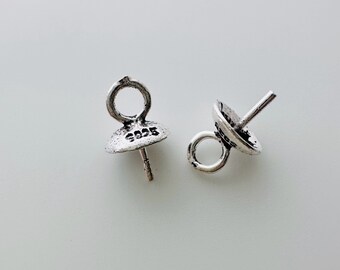 May include: Two silver-toned pendant bails with a loop at the top and a pin at the bottom. The bail on the left has the inscription "925" on the side.