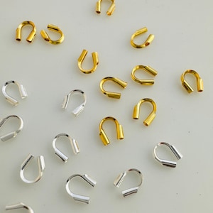May include: A collection of gold and silver jump rings. The jump rings are in various sizes and are ideal for jewelry making.
