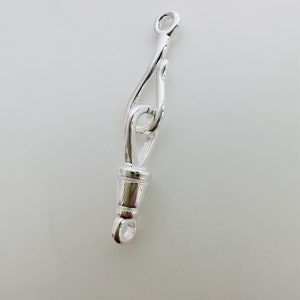 May include: Silver-toned metal clasp with a decorative loop design. The clasp is designed to connect two pieces of jewelry together.
