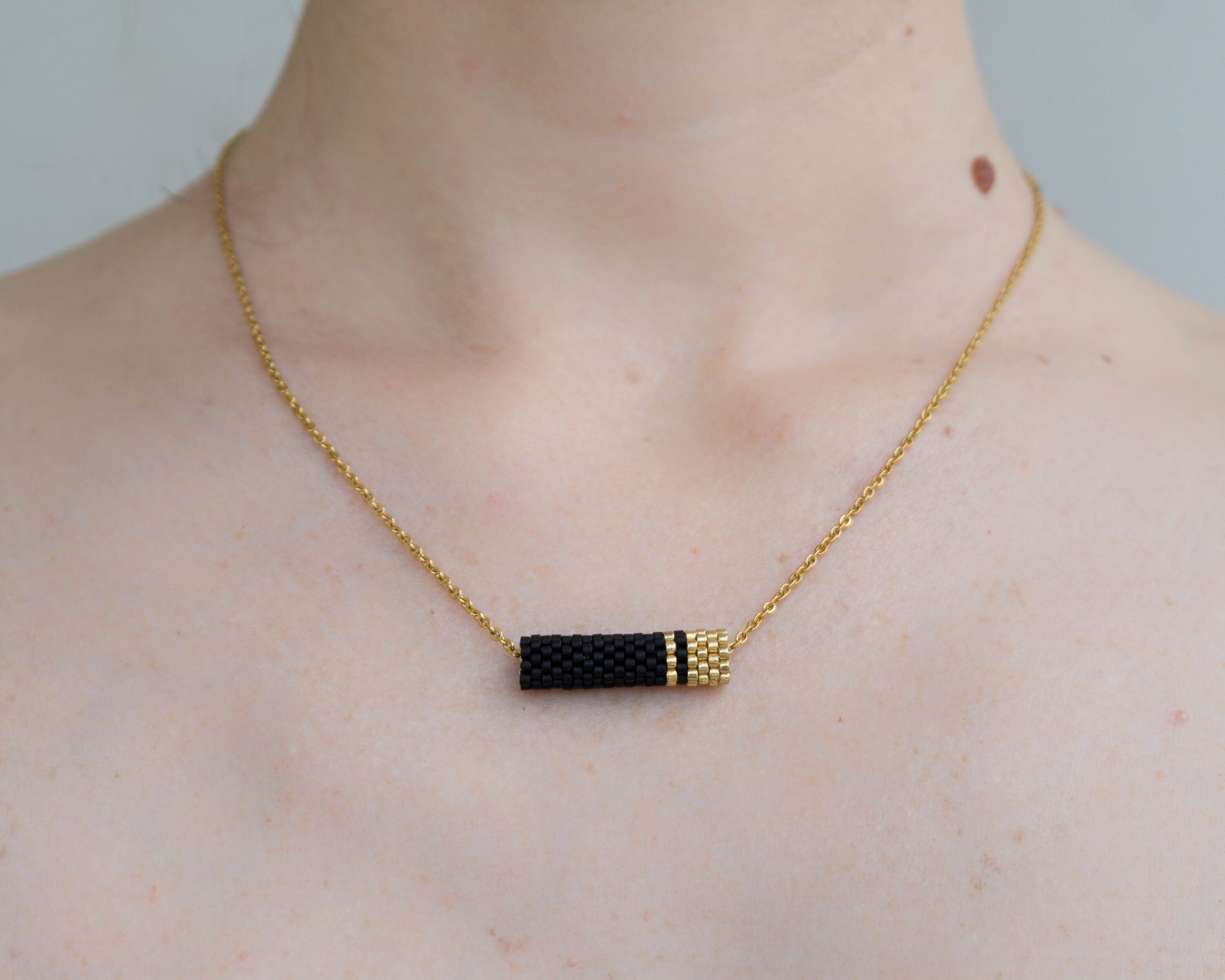 Seed Bead Necklace With Matte Black And Gold Pendant Zoom