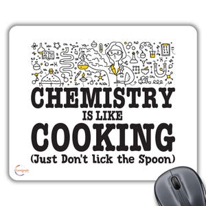 May include: White mouse mat with black text that reads "Chemistry is like cooking (Just Don't Lick the Spoon)". The text is surrounded by a black and yellow illustration of a scientist in a lab coat with chemical formulas and symbols.