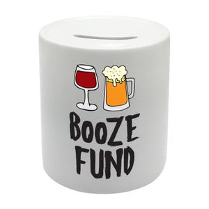 May include: White ceramic money box with a black and white illustration of a glass of wine and a beer mug. The text "Booze Fund" is printed in black below the illustration.