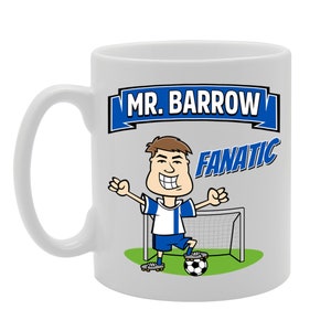 May include: White ceramic mug featuring a cartoon illustration of a person playing football. The mug has blue and white text that reads "Mr. Barrow Fanatic".