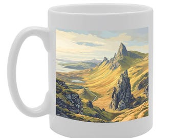 May include: White ceramic mug featuring a scenic image of a mountain range with a winding road leading to a peak. The mountains are a mix of green and brown with a blue sky and white clouds in the background.