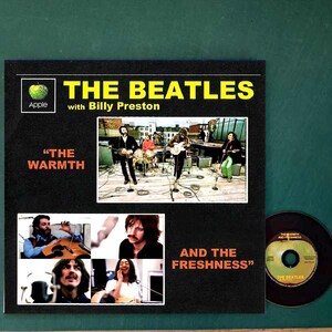 May include: Album cover for "The Beatles with Billy Preston" featuring band photos and text. The album is black with yellow text and an Apple logo. The album title is above a photo of the band playing.