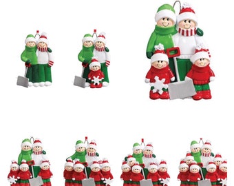 May include: A set of personalized Christmas ornaments featuring a family of four dressed in winter clothing. The family is holding a shovel and a snowflake. The ornaments are available in different sizes to represent families of different sizes.