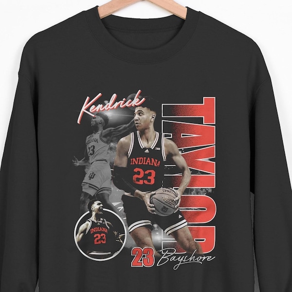 May include: Black sweatshirt with a vintage-style graphic of a basketball player wearing a red and white jersey with the text "Kendrick Taylor 23 Bayhore" printed on the front.