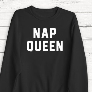 May include: Black sweatshirt with white text that reads "NAP QUEEN".