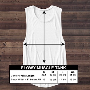 May include: A white flowy muscle tank with a scoop neck, displayed on a wooden surface. The image includes a size chart with measurements in inches for center front length and body width. The tank top is sleeveless.