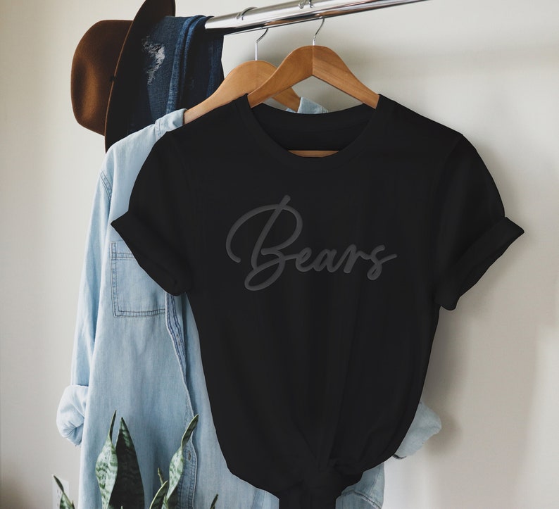 May include: Black t-shirt with the word "Bears" written in a cursive font.