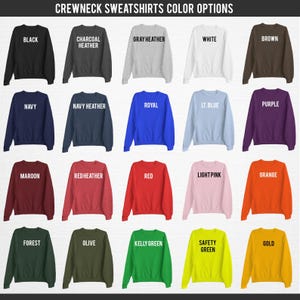 May include: A grid of crewneck sweatshirts in various colors, including black, gray, navy, red, and green. Each sweatshirt displays its color name in white text. The image is labeled "CREWNECK SWEATSHIRTS COLOR OPTIONS".