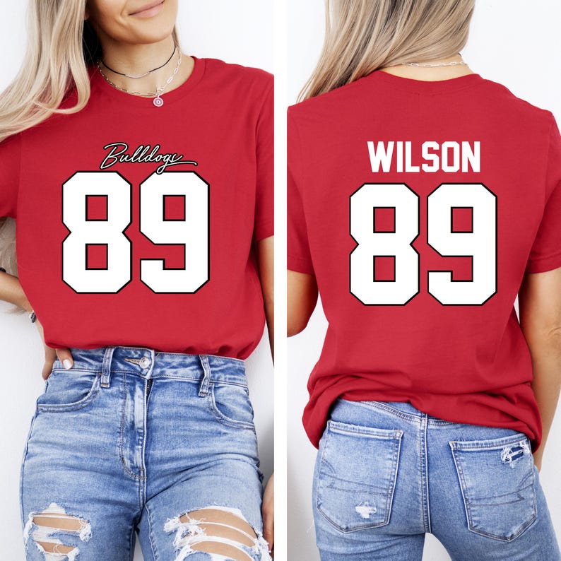 May include: Red t-shirt with the number 89 in white, outlined in black. The front of the shirt has the word "Bulldogs" in cursive above the number. The back of the shirt has the name "WILSON" above the number 89.