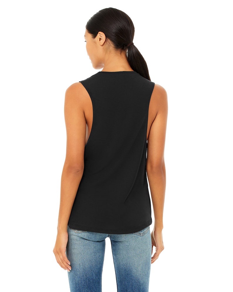 May include: Black sleeveless muscle tank top with a relaxed fit. The tank top is made of a soft, comfortable fabric.
