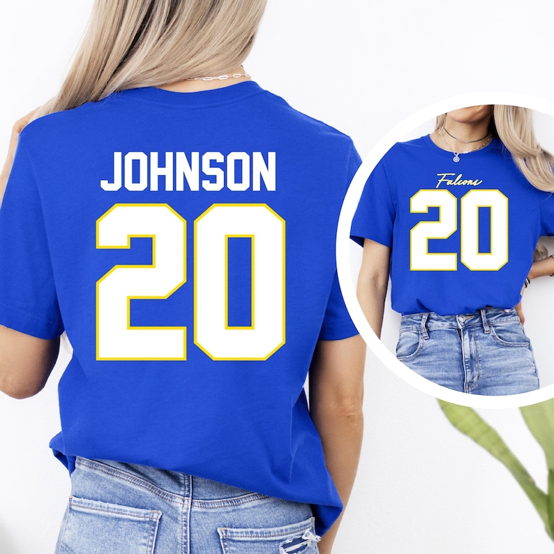 May include: Royal blue t-shirt with the name "JOHNSON" and the number "20" in white with a yellow outline. A smaller image shows a similar blue shirt with "Falcons" and the number "20".