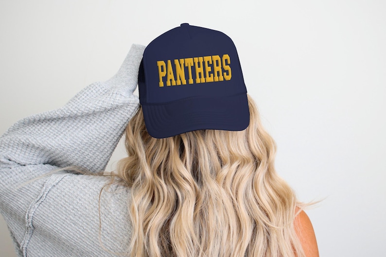 May include: A navy blue trucker hat with a gold embroidered "PANTHERS" logo.